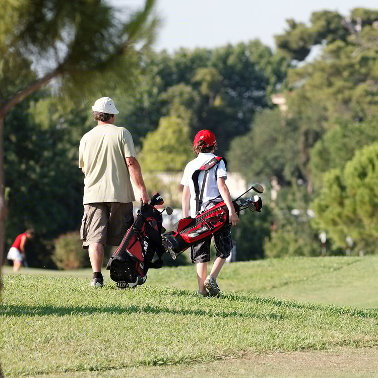 Adult and junior golfer on the course
