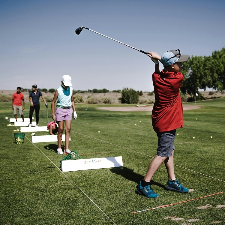 Beginner junior golfers competing with each other